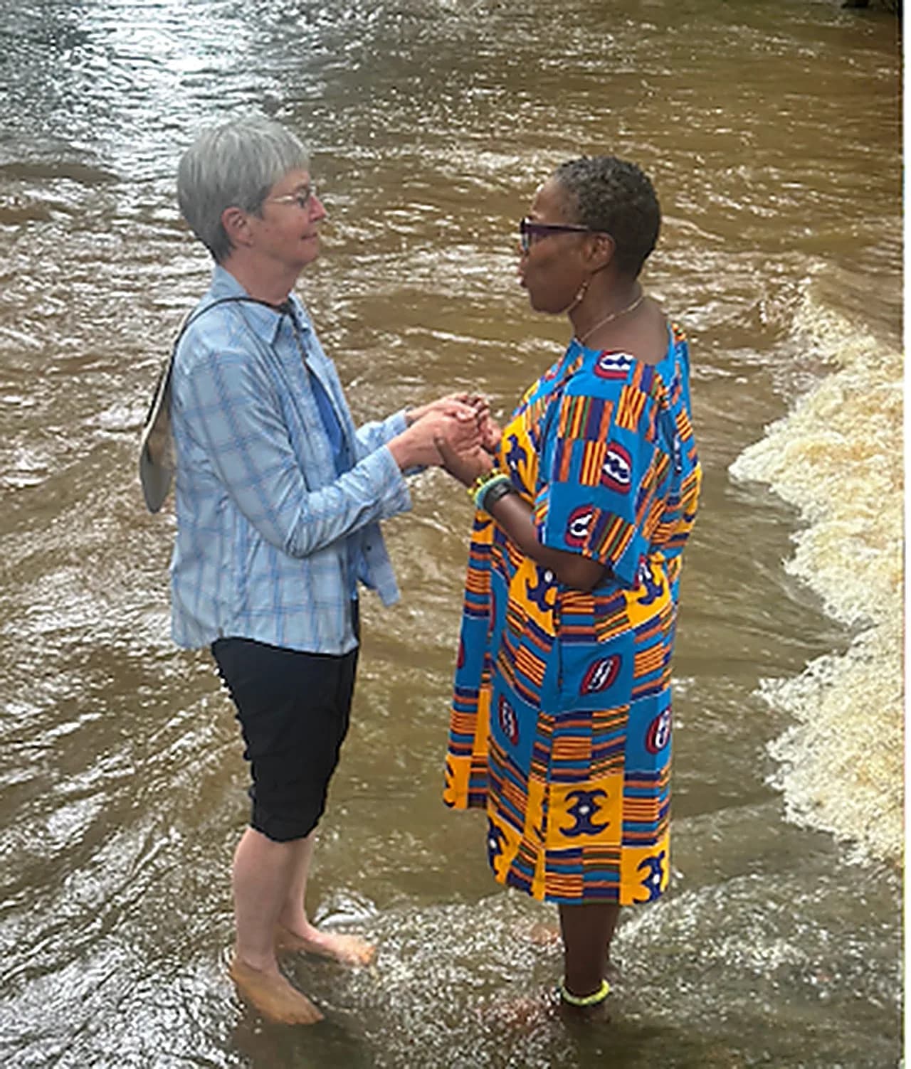 Two women connecting at the Assin Manso slave river
